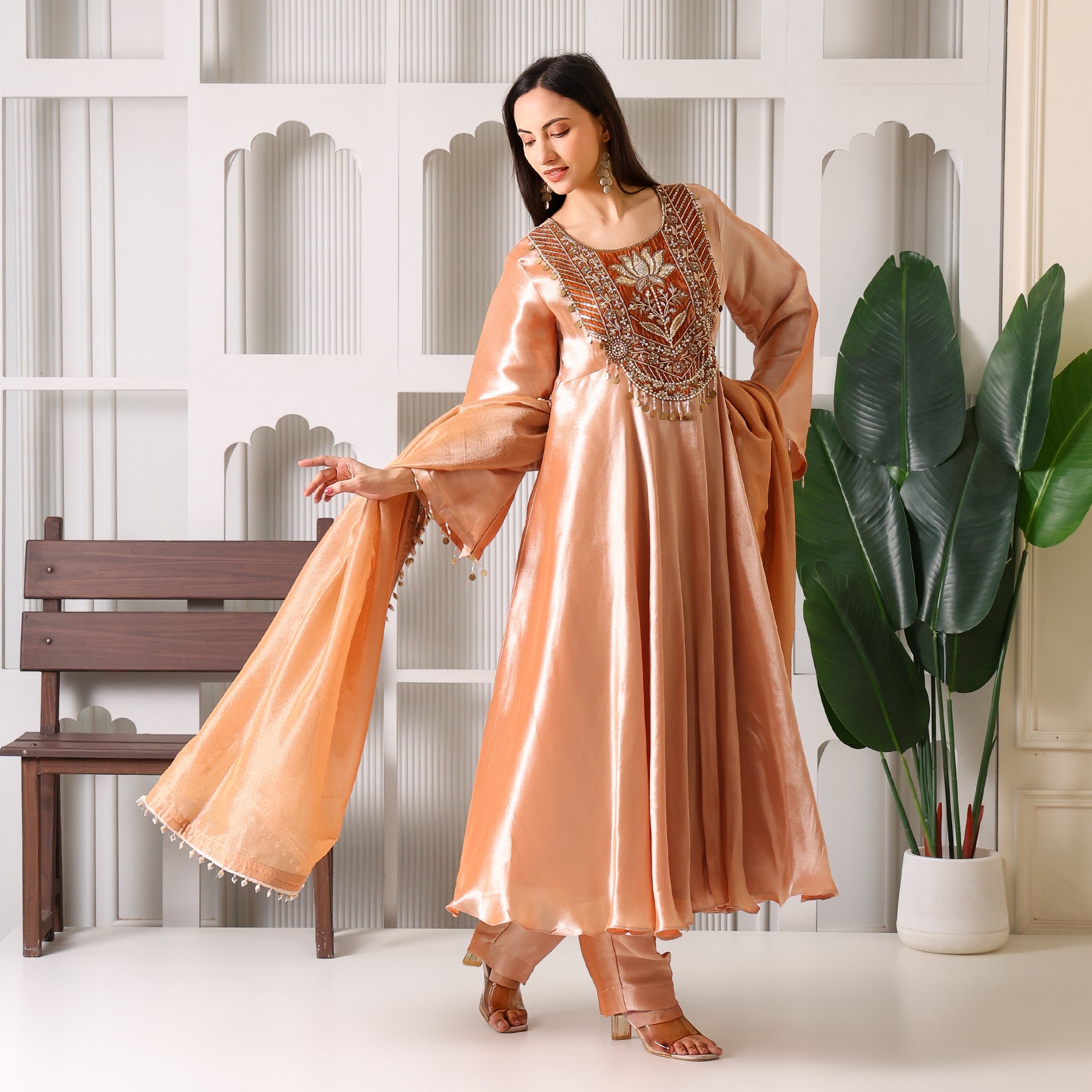 Woman wearing peach Banarasi Anarkali suit with embroidery, dupatta, and matching pants