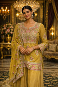 Woman in mustard yellow embroidered Anarkali suit with dupatta, traditional festive attire