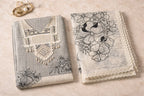Elegant grey and white ethnic suit set with floral embroidery and lace, styled on marble surface.
