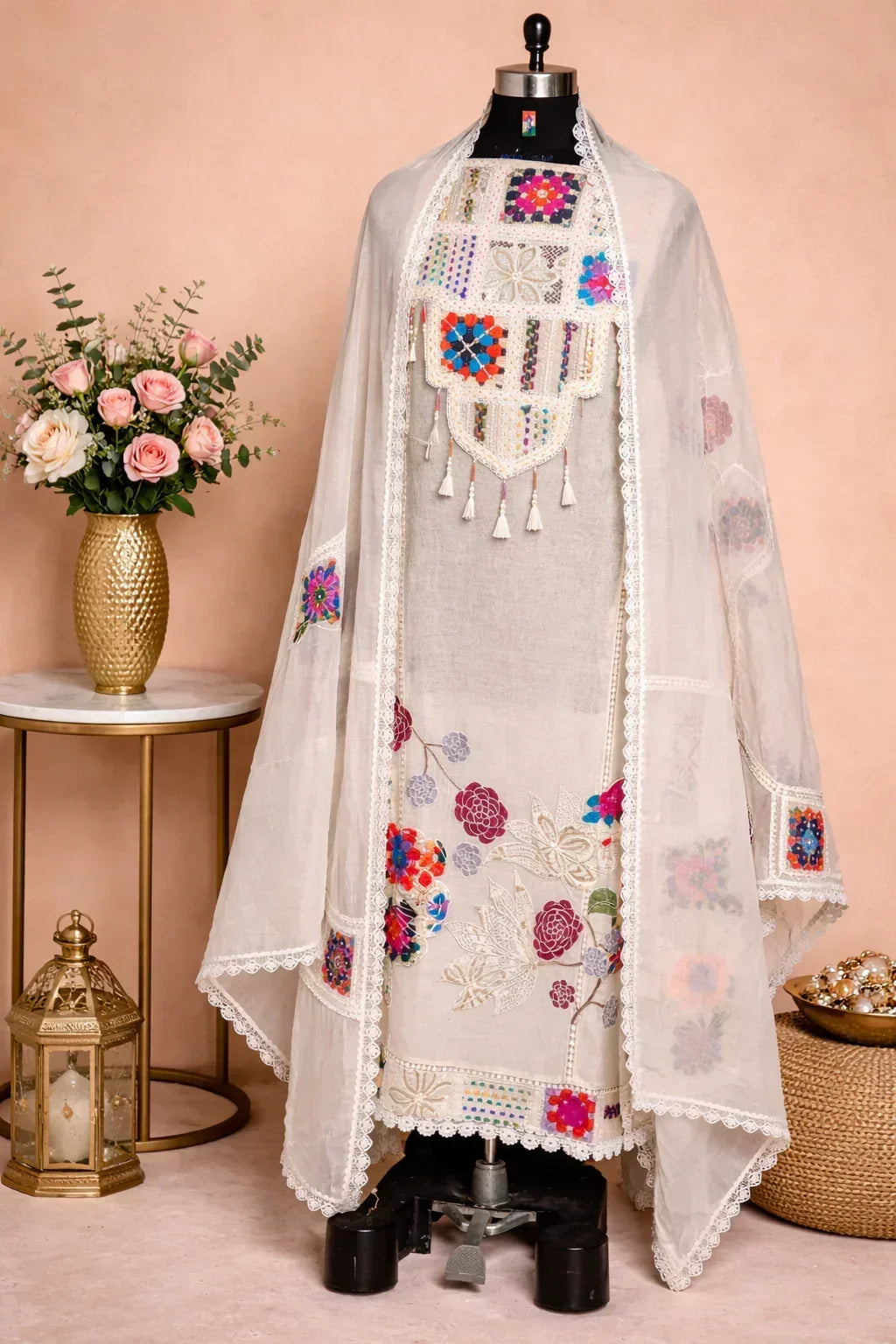 Ivory embroidered Anarkali suit with floral sequin and threadwork, displayed on mannequin