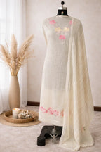 Ivory ethnic kurta set with pastel floral embroidery and sheer dupatta displayed on mannequin