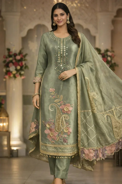 Woman in sage green embroidered salwar kameez set with floral dupatta, festive ethnic wear