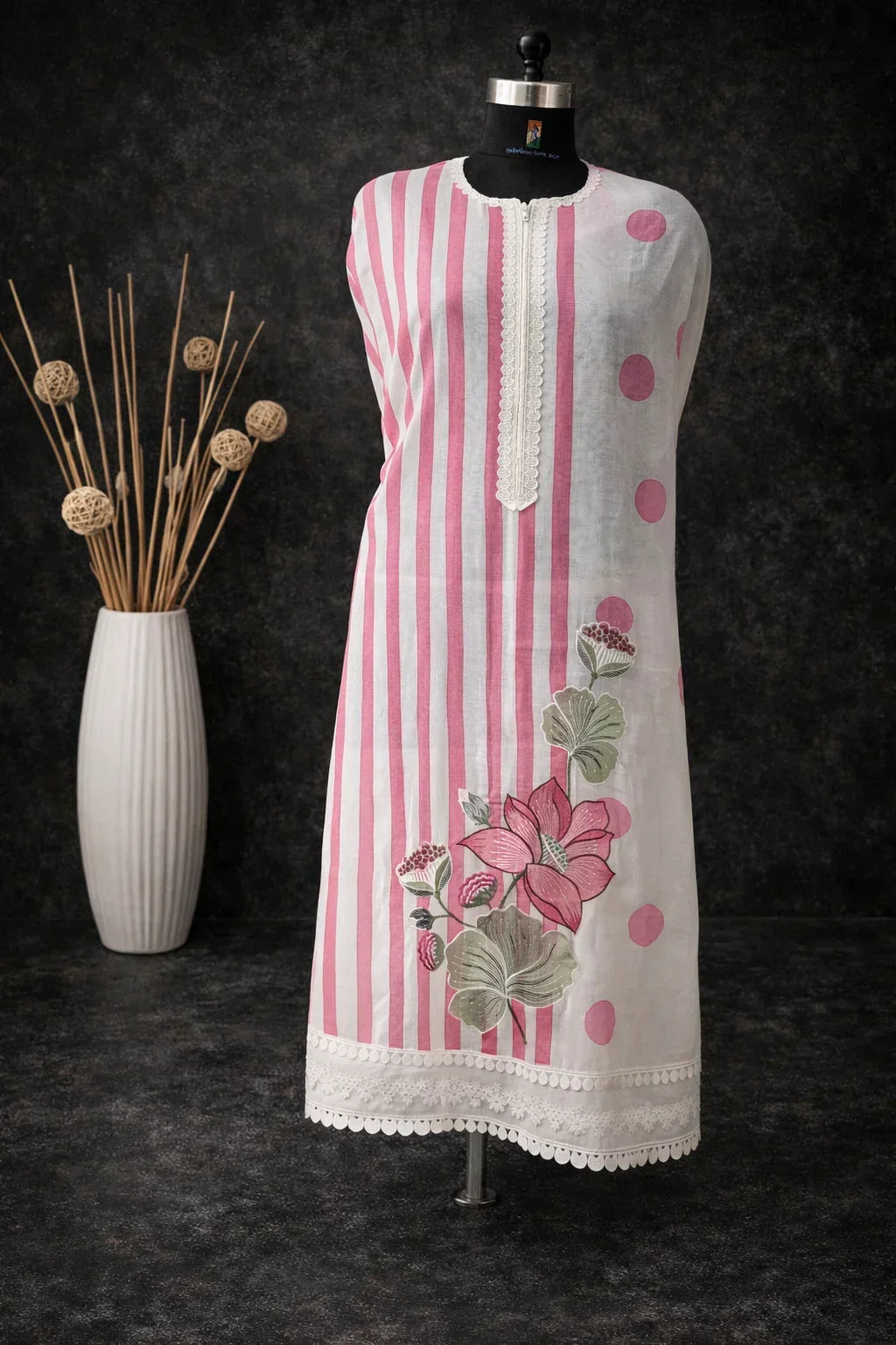 Pink and white striped ethnic kurta with floral print and lace trim on mannequin