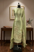 Pastel green Anarkali suit with intricate embroidery and dupatta on a mannequin