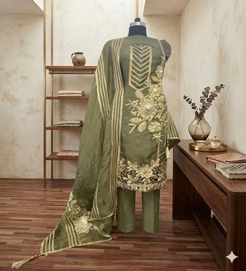Olive green embroidered ethnic suit set with floral detailing and dupatta on mannequin