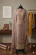 Embroidered mauve Anarkali suit with floral patterns and dupatta on mannequin