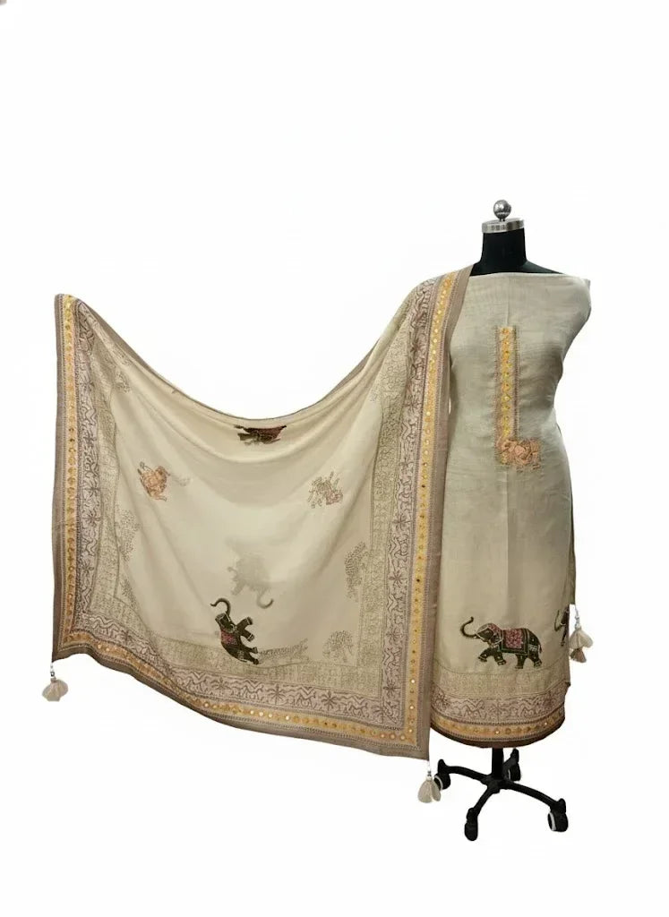 Ivory ethnic suit with embroidered dupatta featuring elephant motifs and gold detailing