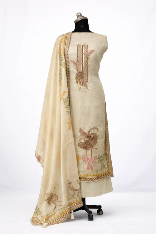 Ivory ethnic suit set with brown bird embroidery and floral dupatta on mannequin