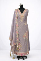 Lavender Anarkali suit with gold embroidery, floral motifs, and matching dupatta on mannequin