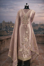 Embroidered mauve Anarkali suit with floral and mirror work, displayed on a mannequin outdoors