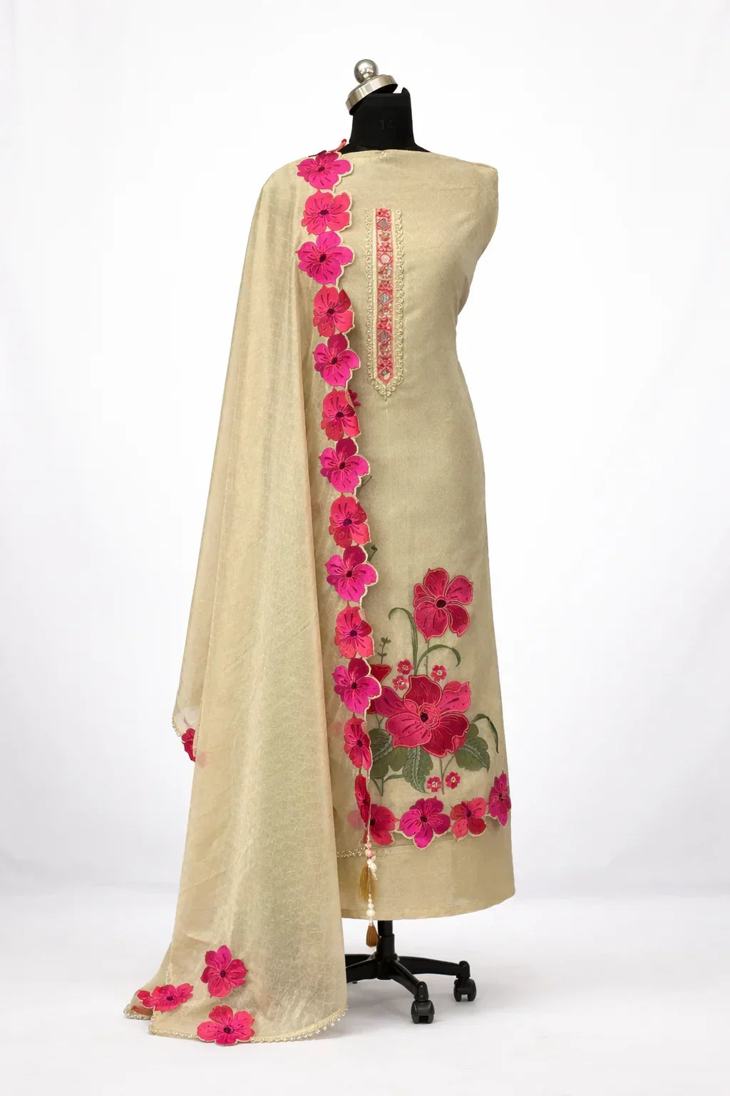 Beige ethnic suit with pink floral embroidery and matching dupatta on mannequin