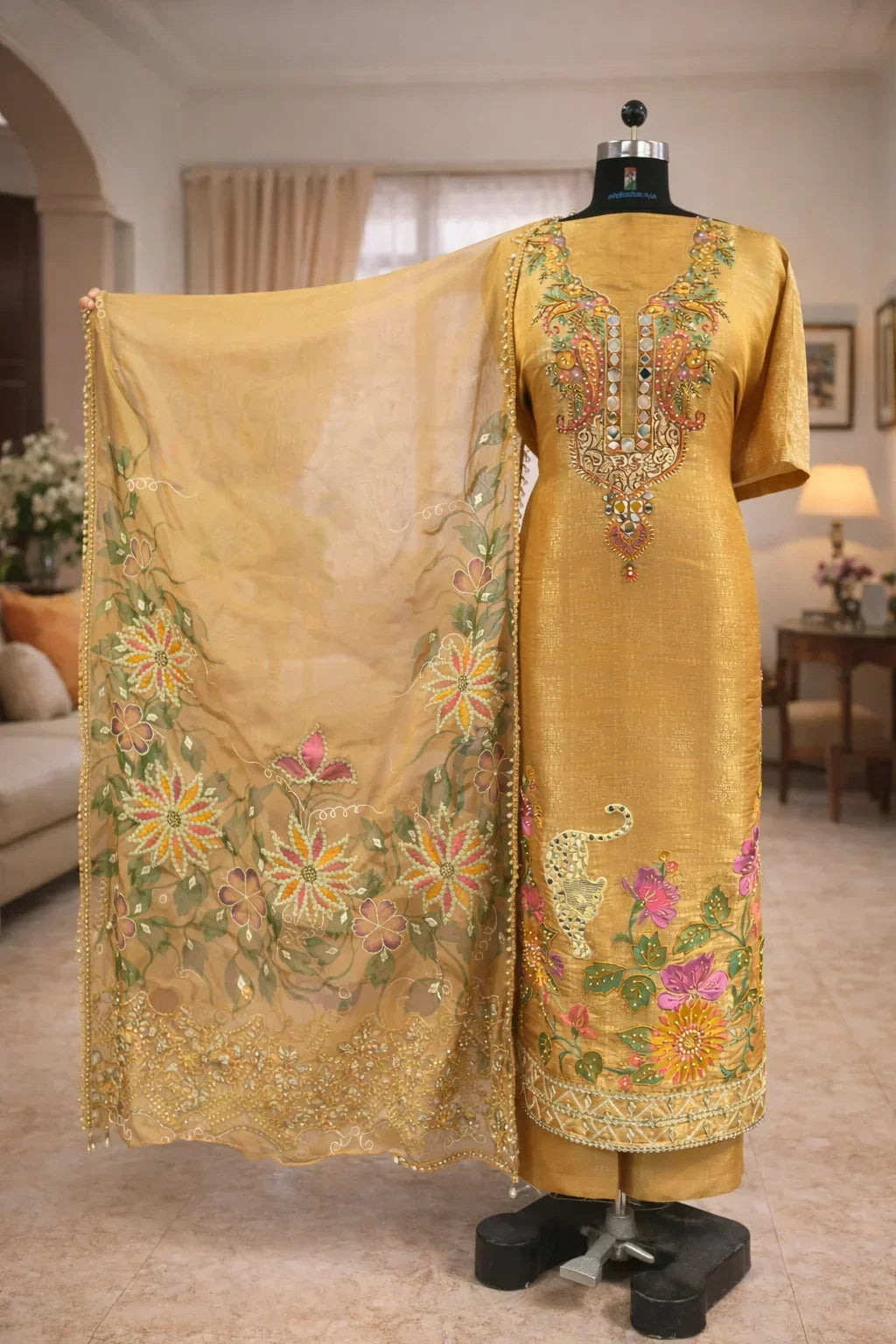 Golden ethnic suit with floral embroidery and matching dupatta, ideal for weddings or festive wear