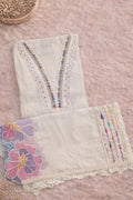 White ethnic fabric with colorful embroidery, lace trim, and pastel floral details, flat lay