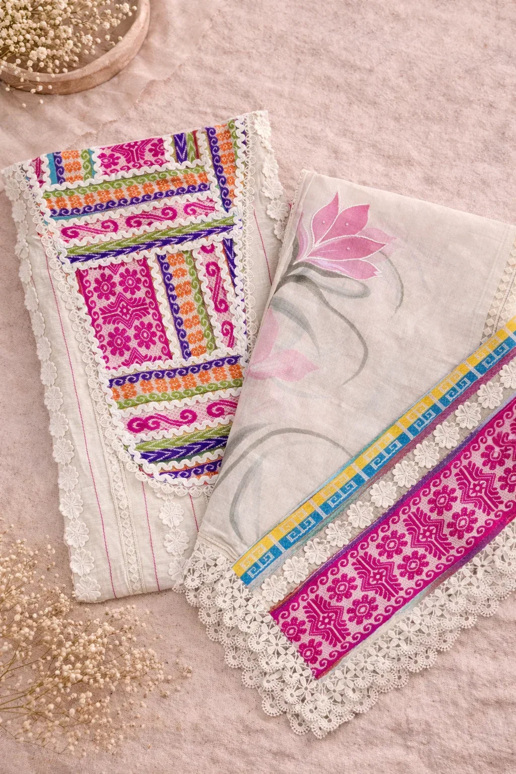 Flat lay of luxury ethnic fabric with colorful embroidery, floral print, and lace trim