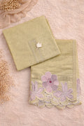 Pastel green ethnic fabric set with pink floral embroidery and lace detailing, flat lay