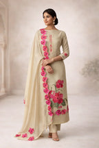 Woman wearing beige ethnic suit with pink floral embroidery and matching dupatta