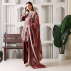 Woman in maroon Banarasi Anarkali suit with dupatta, traditional ethnic wear, indoor setting