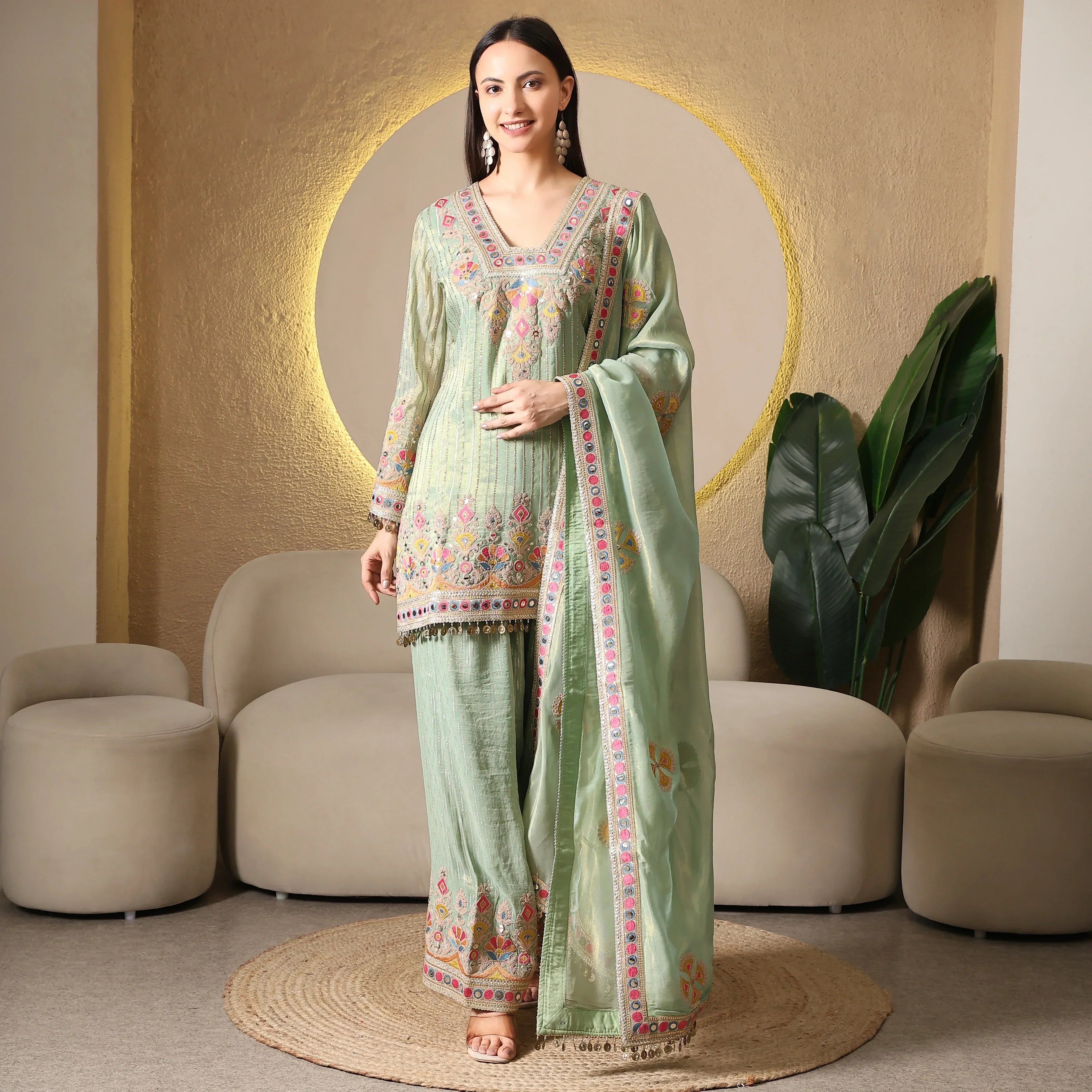 Woman in pastel green embroidered ethnic suit with matching dupatta and palazzo pants