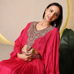 Woman in pink embellished ethnic outfit with statement earrings, ideal for festive occasions