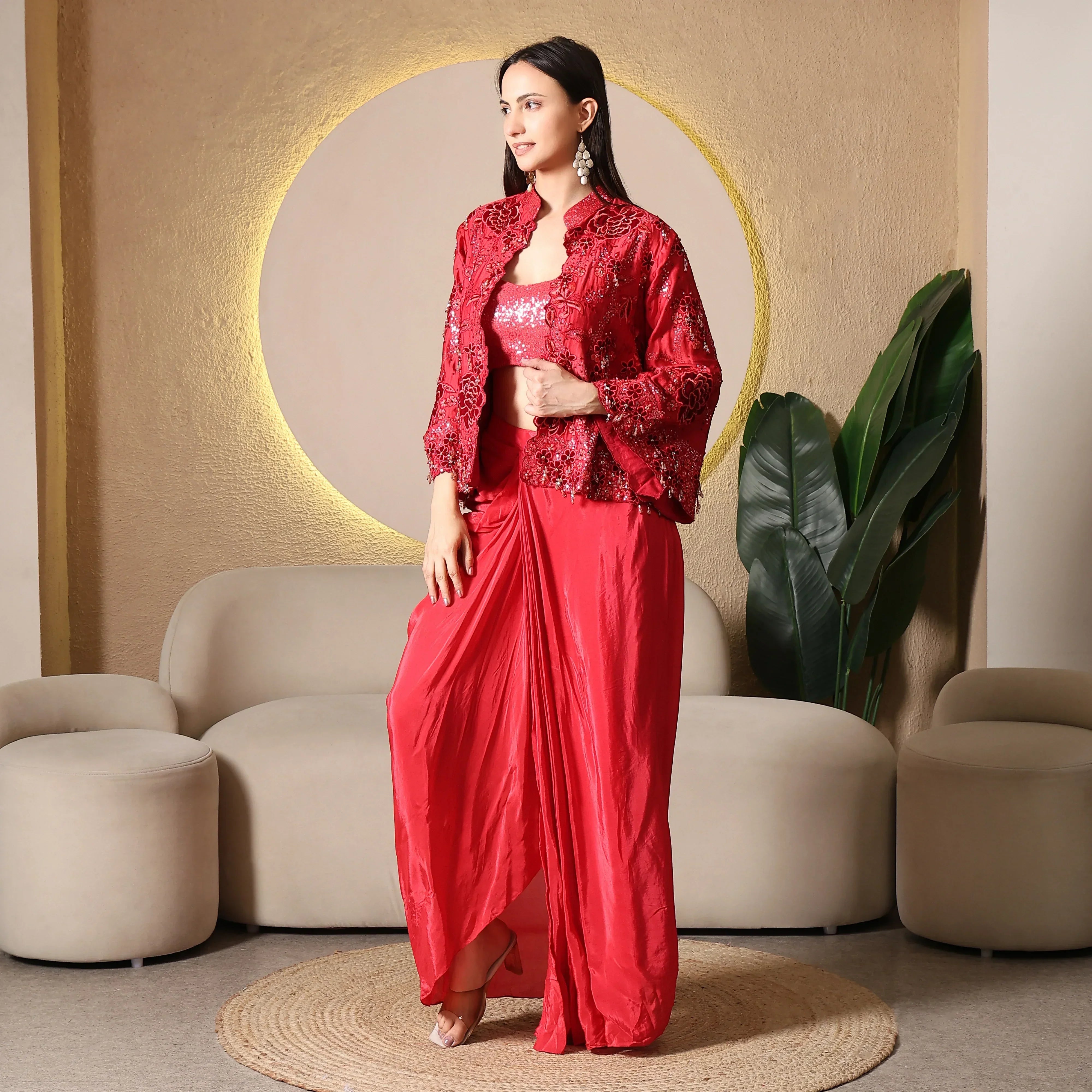 Woman in red embellished ethnic three-piece set with draped pants, festive wear