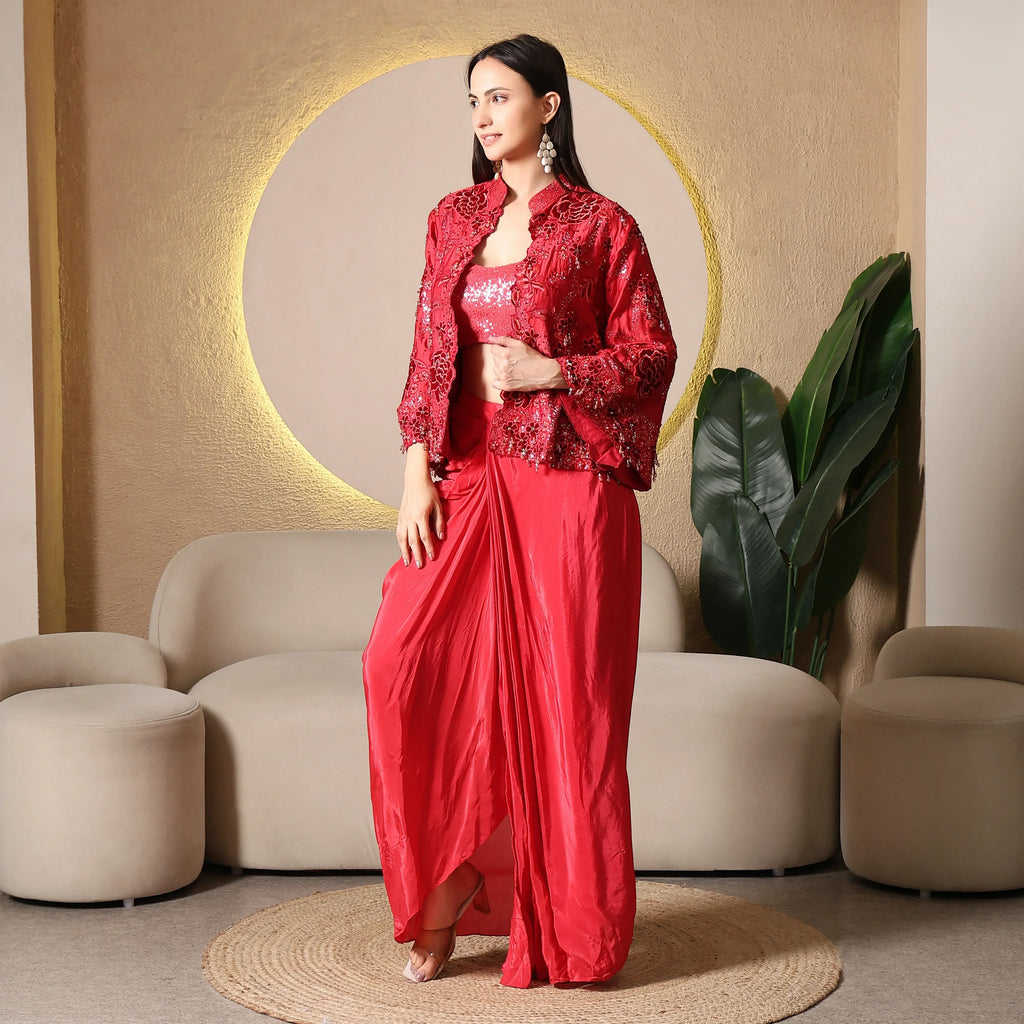Woman in red embellished ethnic three-piece set with draped pants, festive wear