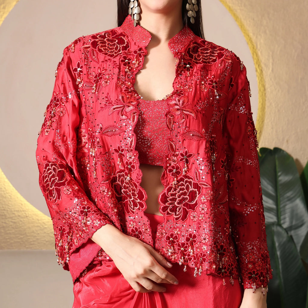 Woman wearing a red embroidered ethnic jacket with sequin floral detailing