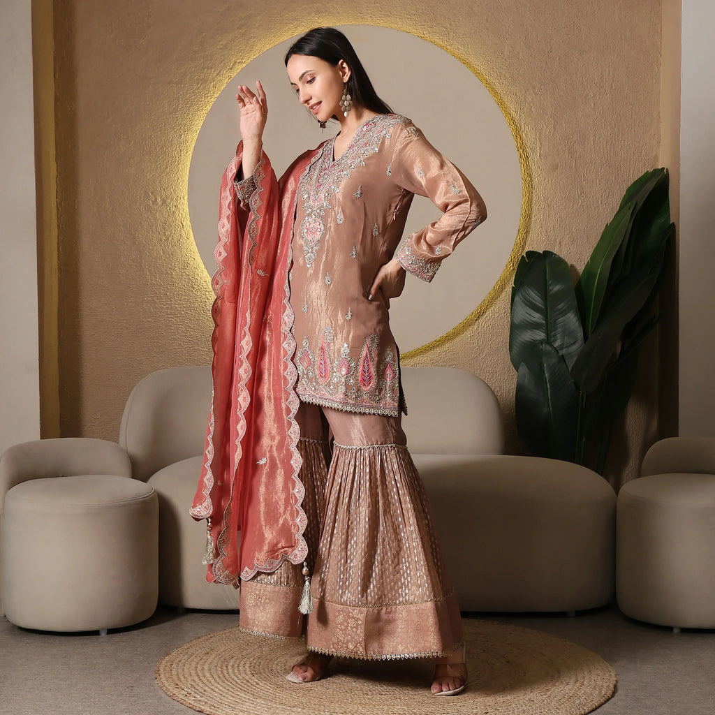 Woman wearing embroidered sharara suit with dupatta, ideal for festive ethnic wear