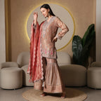 Woman wearing embroidered sharara suit with dupatta, ideal for festive ethnic wear
