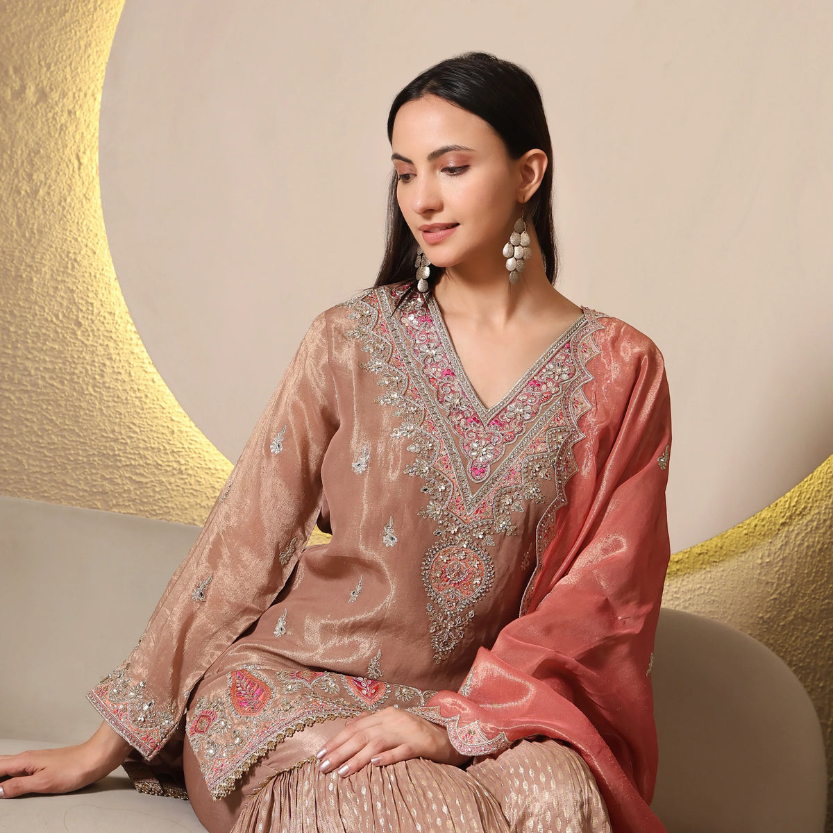Woman in embroidered Banarasi Anarkali suit with pink dupatta, ethnic jewelry, festive wear