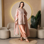 Woman in pastel pink embroidered ethnic suit with dupatta, ideal for festive or wedding wear