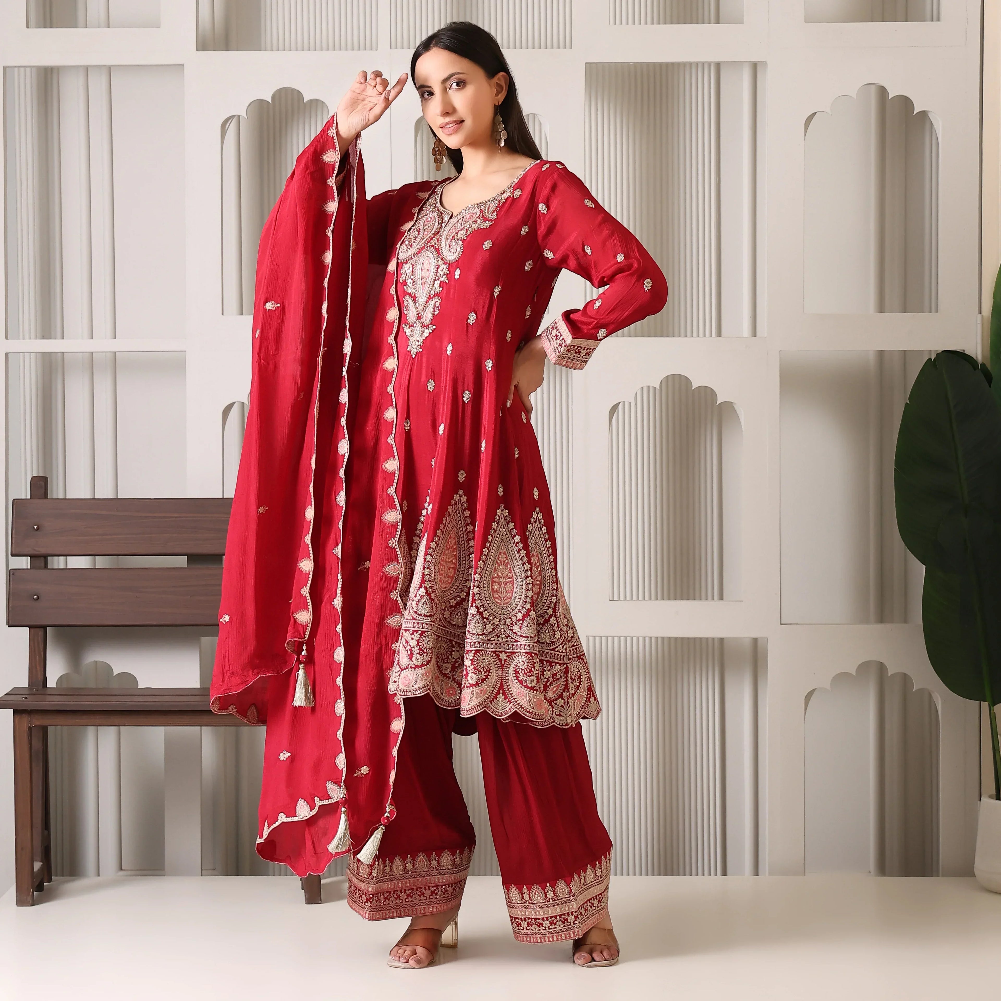 Woman wearing maroon embroidered Banarasi Anarkali suit with dupatta and palazzo pants