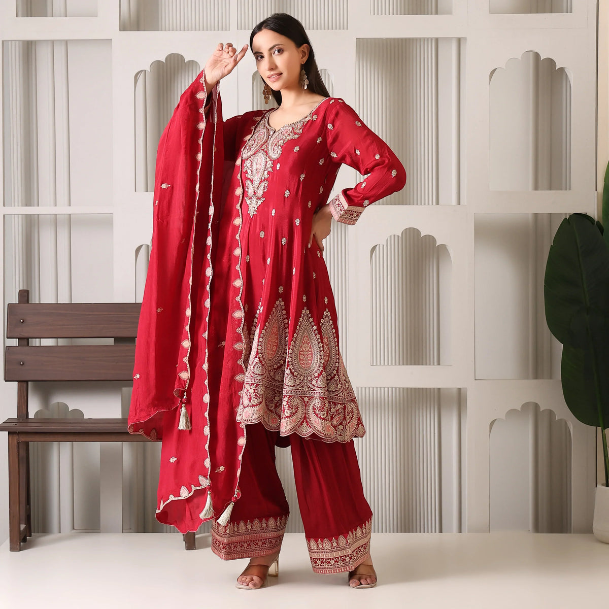 Woman wearing maroon embroidered Banarasi Anarkali suit with dupatta and palazzo pants