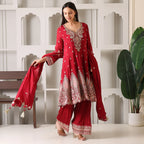 Woman in a red Banarasi Anarkali suit with dupatta, featuring intricate embroidery