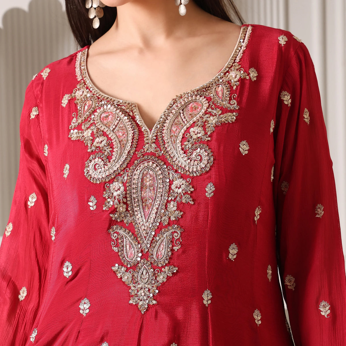 Red silk Anarkali suit with intricate gold embroidery and paisley motifs, festive ethnic wear
