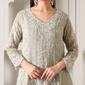 Pastel green embroidered ethnic suit with sheer sleeves and intricate white beadwork