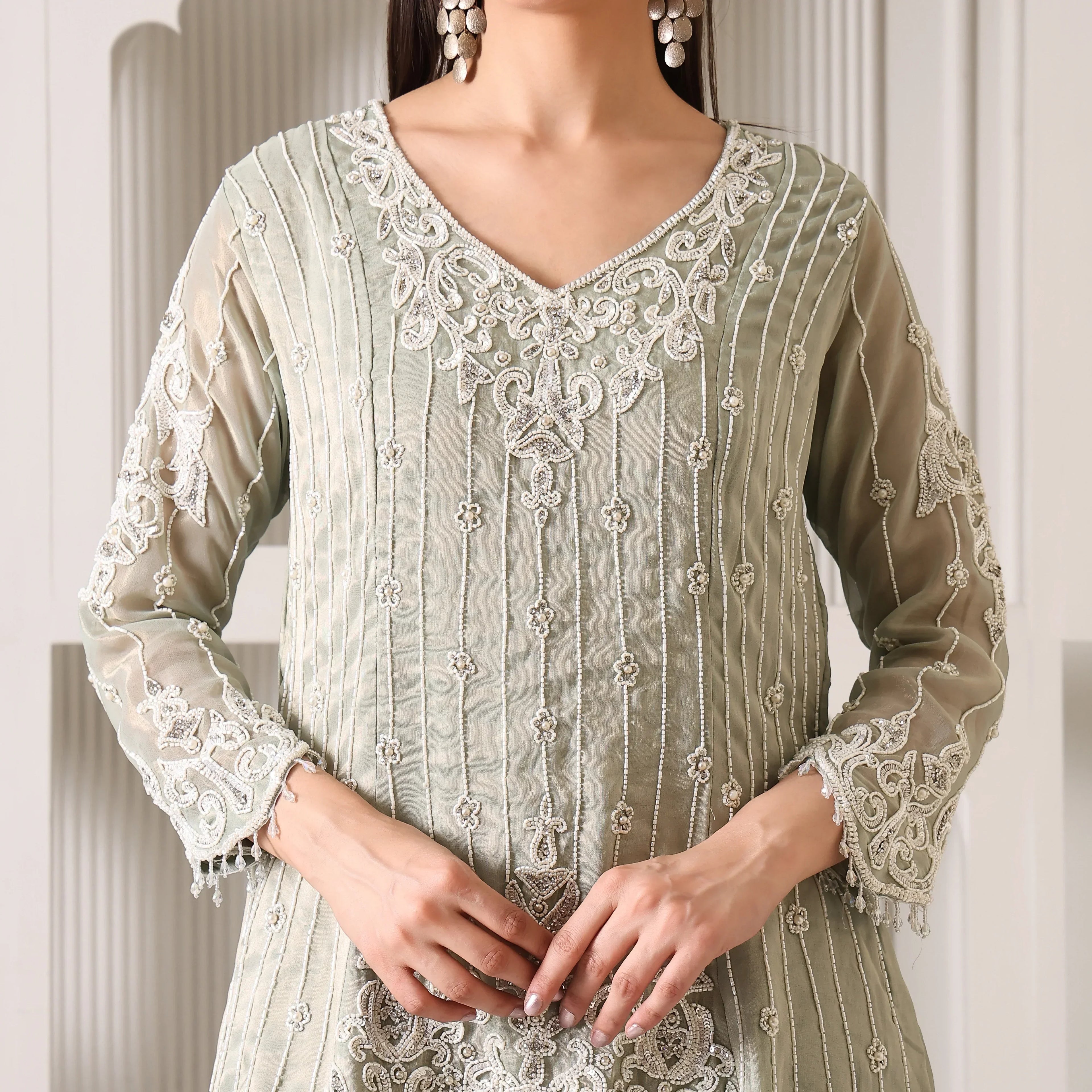 Pastel green embroidered ethnic suit with sheer sleeves and intricate white beadwork