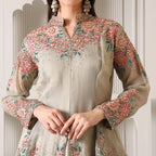 Woman wearing pastel embroidered ethnic suit with floral beadwork and long sleeves
