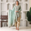 Woman in pastel green embroidered ethnic kurta with matching dupatta and beige pants