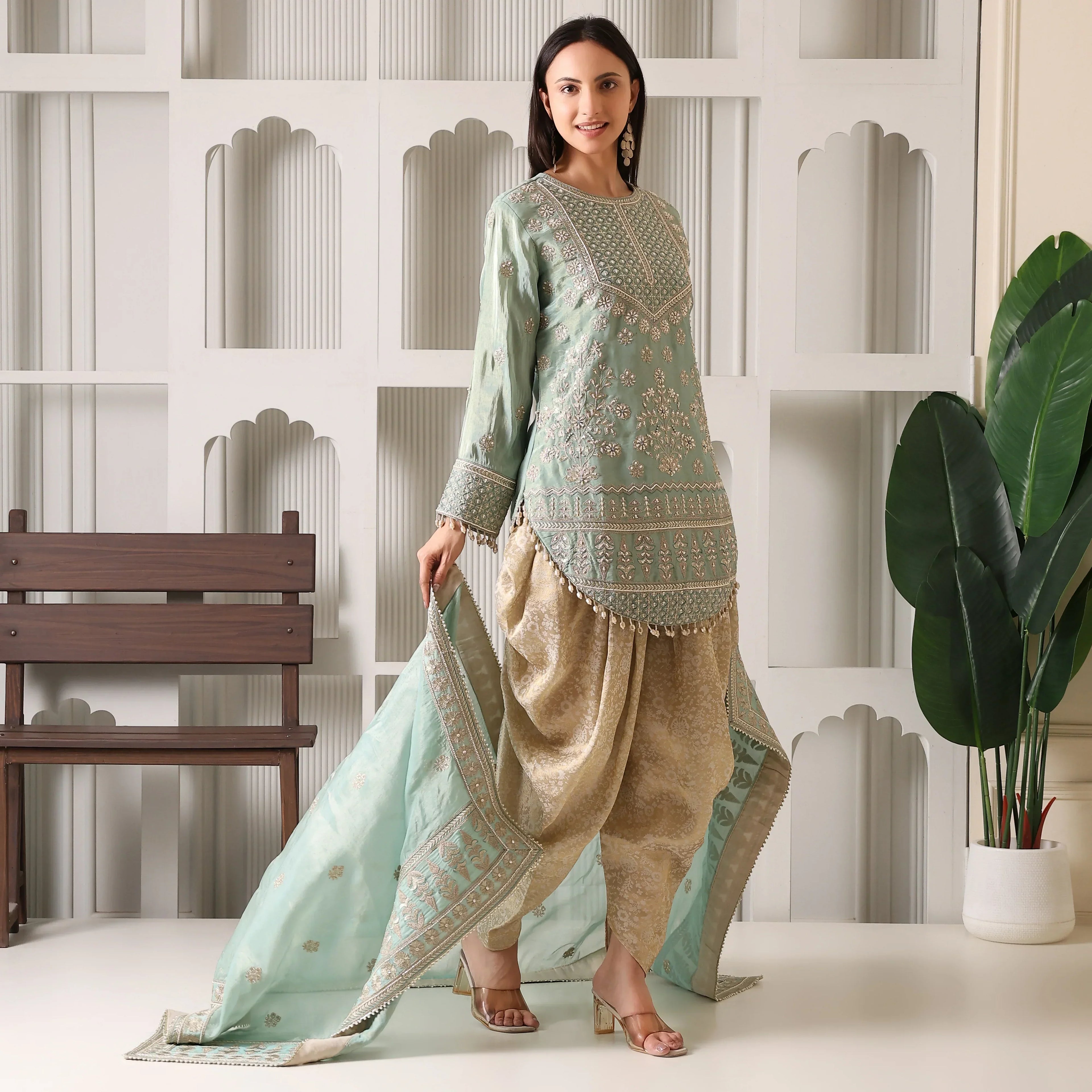 Woman in mint green embroidered kurta with gold dhoti pants and matching dupatta, ethnic wear
