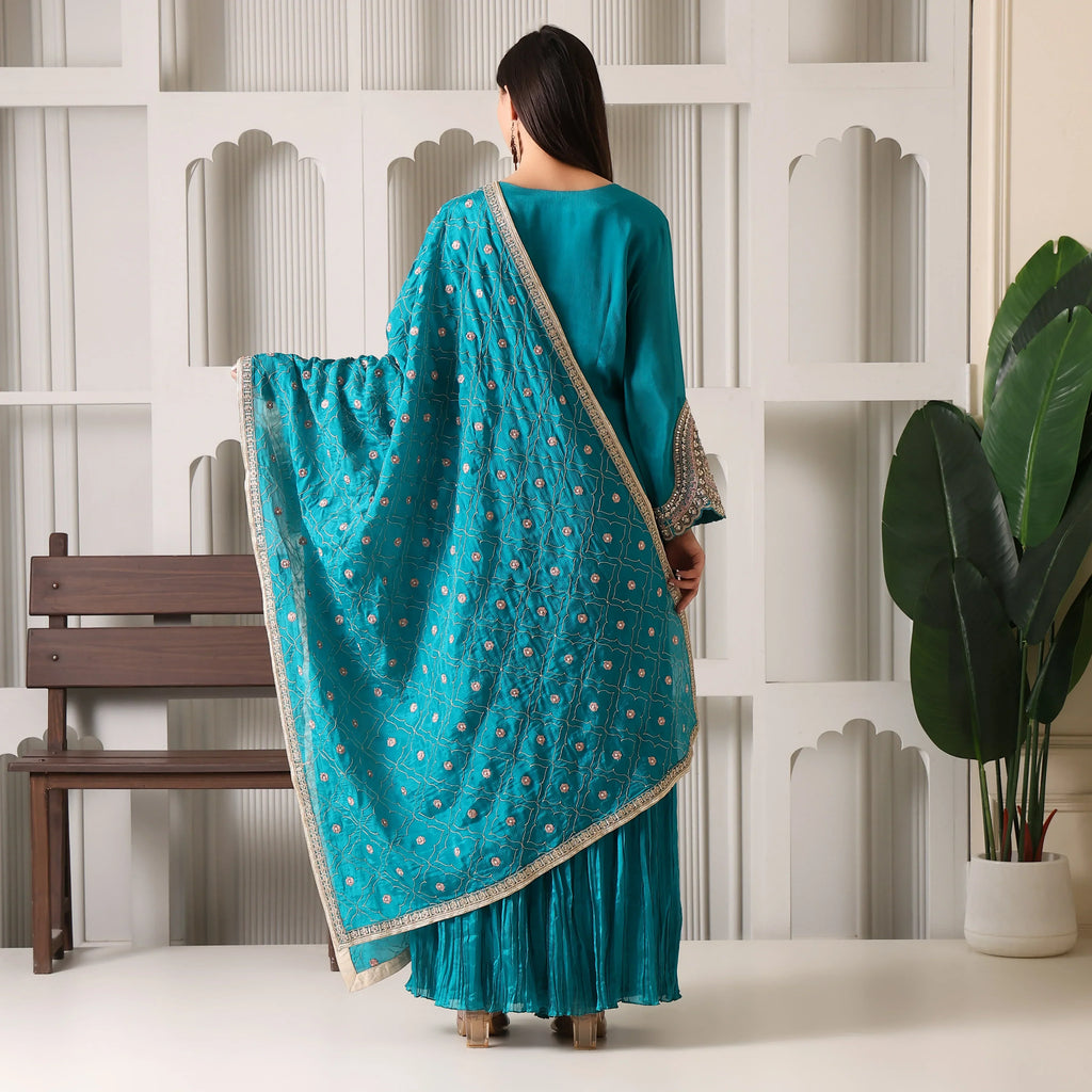 Woman in teal embroidered Anarkali suit with dupatta, traditional ethnic wear, back view