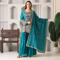 Woman wearing teal embroidered ethnic suit with matching dupatta, palazzo pants, festive outfit