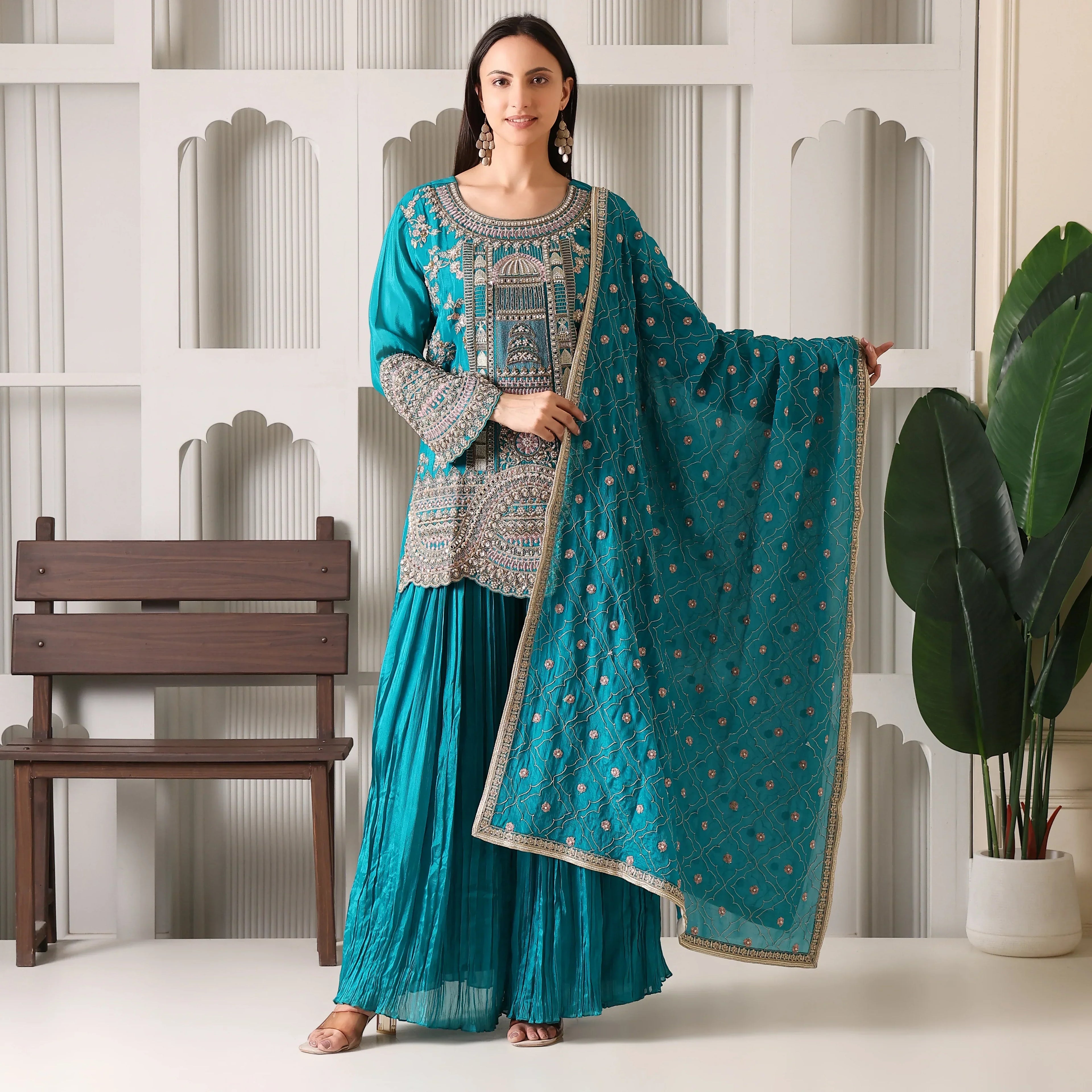 Woman wearing teal embroidered ethnic suit with matching dupatta, palazzo pants, festive outfit