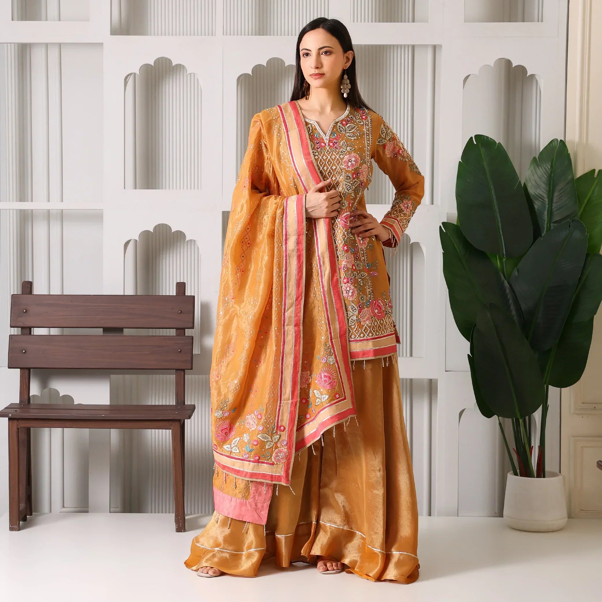 Woman in mustard yellow embroidered Anarkali suit with dupatta, festive ethnic wear
