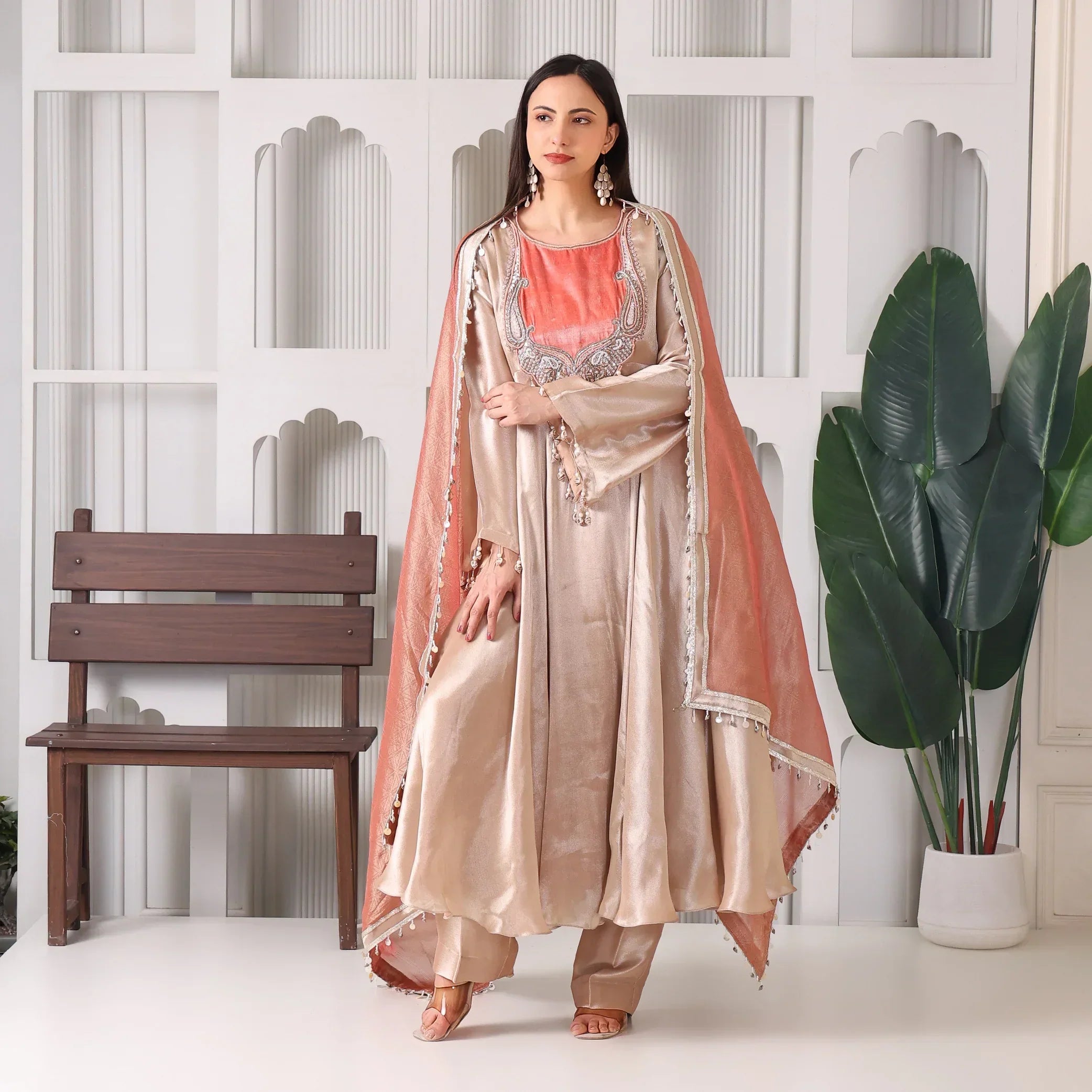 Woman in beige Banarasi Anarkali suit with coral dupatta, festive ethnic fashion