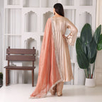 Woman in beige Anarkali suit with peach dupatta, ethnic wear, indoor setting