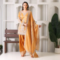 Woman wearing mustard embroidered ethnic suit with dupatta in a modern interior setting
