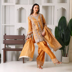 Woman in gold embroidered ethnic suit with matching dupatta, festive designer outfit