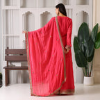 Woman in pink ethnic suit set with embroidered dupatta, indoor festive fashion