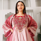 Woman in pink Banarasi Anarkali suit with intricate embroidery and dupatta