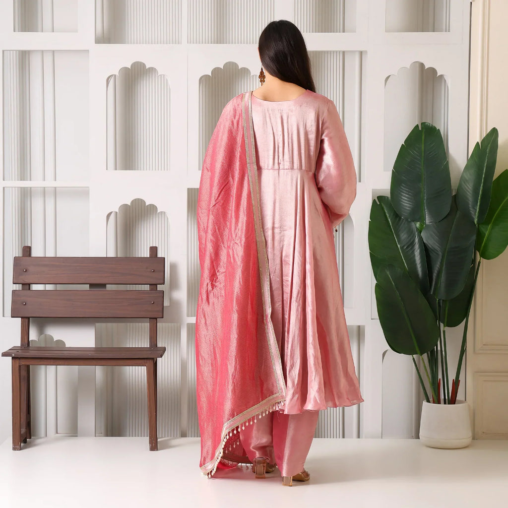 Woman in a pink Banarasi Anarkali suit with dupatta, back view, indoor setting